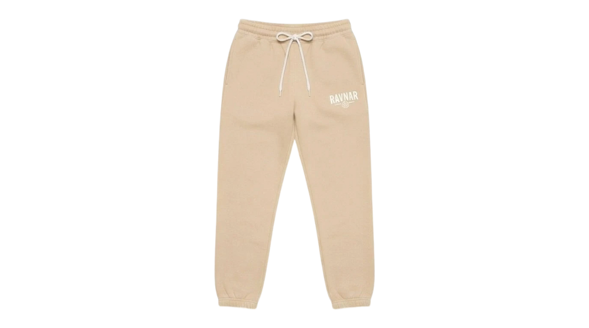 Ravnar beige heavyweight sweatpants with a drawstring waist and white logo embroidery on a grey background