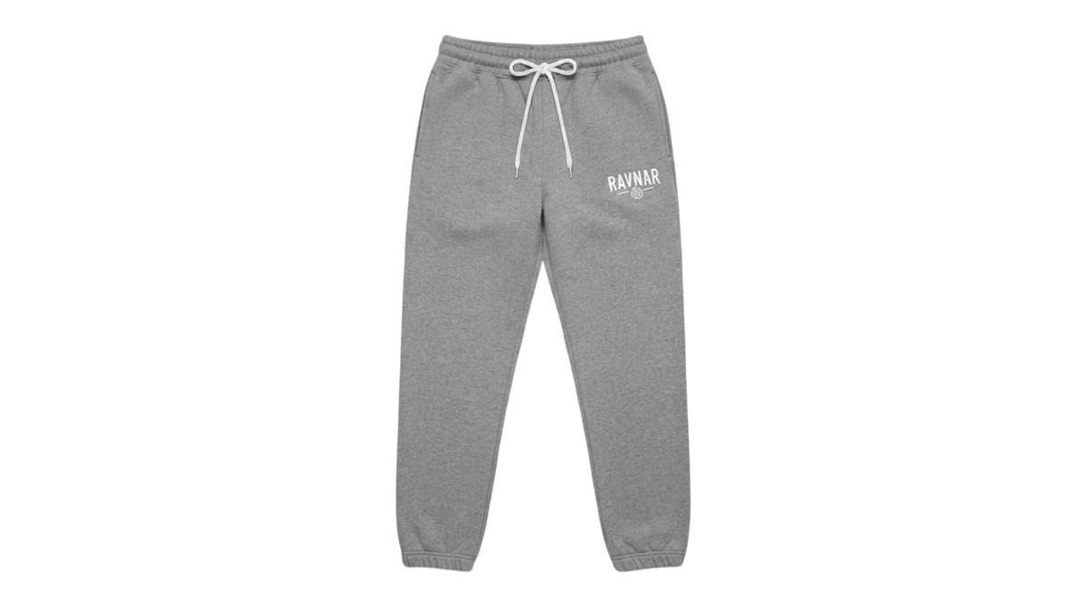 Ravnar grey heavyweight sweatpants with a white drawstring and logo detail on a neutral concrete background