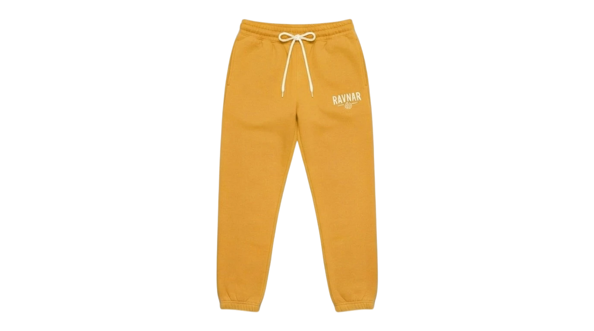 Ravnar heavyweight yellow sweatpants with a drawstring waist and white logo embroidery on a grey background